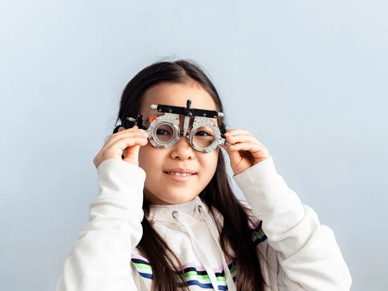 A girl trying on a trial frame during an eye exam